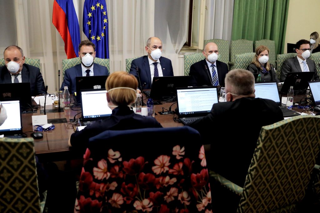 Photo of Slovenian national officials meeting during the corona crisis. All are wearing masks.